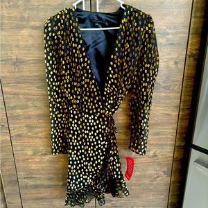 Brand new, Black with gold circles, long sleeve with whimsical frill at bottom.